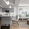 Model kitchen and living room at our apartments in Dallas, featuring wood grain floor paneling and a kitchen island.