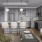 Model kitchen and living room at our apartments in Turtle Creek, TX featuring wood grain floor paneling and a kitchen island.