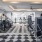 The fitness center at our apartments for rent in Dallas, TX featuring exercise machines and free weights.