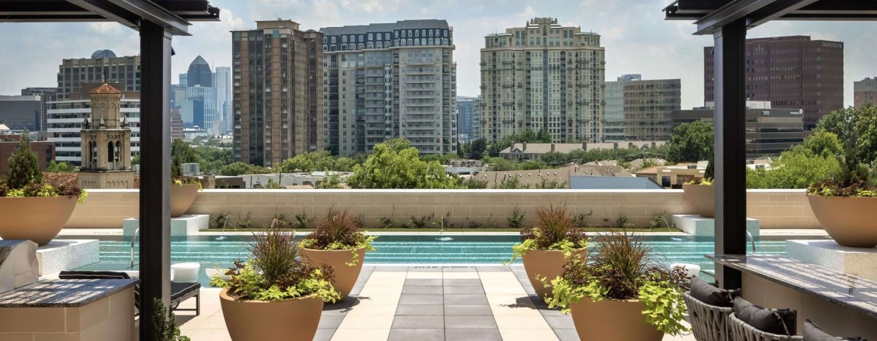 a pool and a deck with a view of a city
