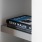 Bookshelf at our apartments for rent in Dallas, TX, featuring a book on its side and grey shelving units.