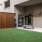 a room with a bench and green turf