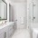 Model bathroom at our apartments for rent in Dallas, TX, featuring marble pattern floors and a shower with a glass door.